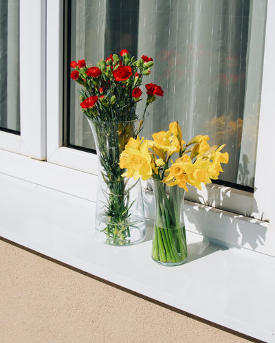 Skleněné vázy Simax Rose s květinami na okně